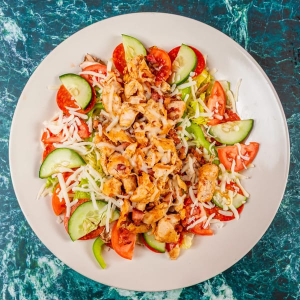 Mugsy's Hideout's Italian salad with chicken, pepperoni, tomatoes, cucumbers, and shredded cheese.